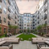 courtyard with seating and grass between two buildings