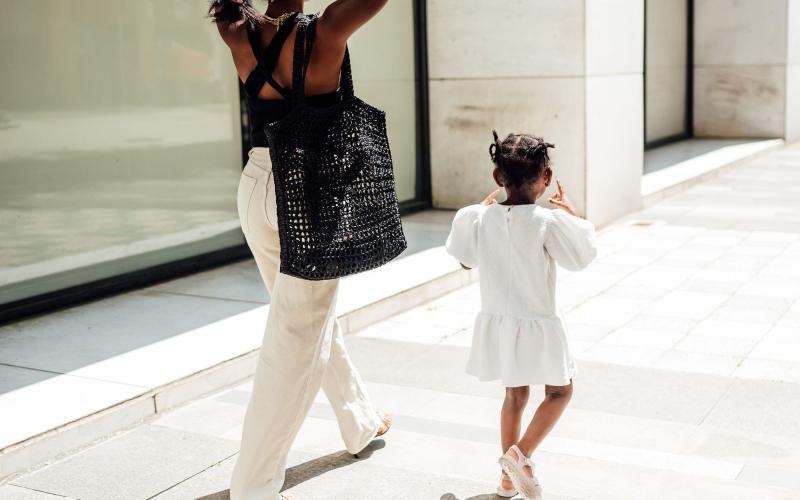 a woman walking with her child