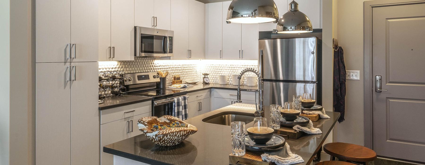 a kitchen with a bar stool and a bar stool