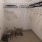 a closet with a shelves hangers and basket s