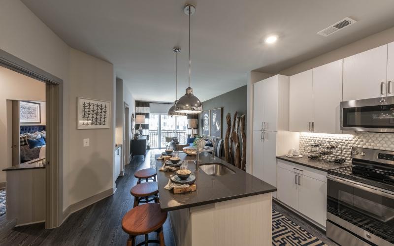 a kitchen with a bar and stools