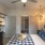 a bedroom with a bed ceiling fan and a table