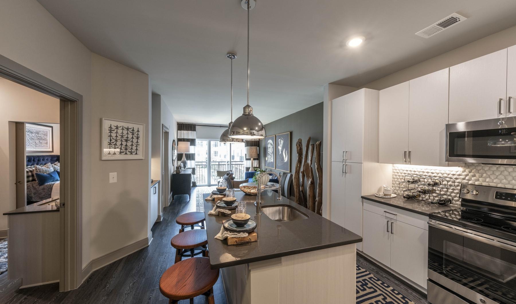 a kitchen with a bar and stools